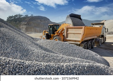 Wheel Loader Loads A Truck With Sand In A Gravel Pit