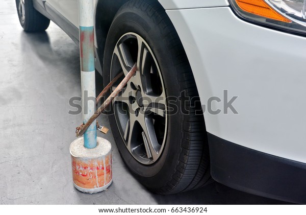 wheel lock , Car\
clamped on cobbled street