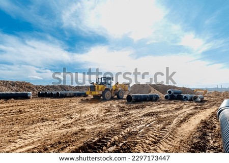 Wheel machine for loading performs work on laying large diameter pipes.