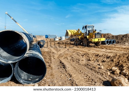 Wheel machine for loading performs work on laying large diameter pipes.