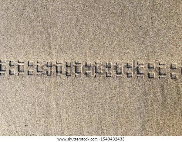 \
Wheel marks on the sandy\
beach