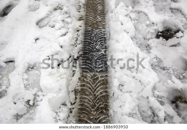 Wheel marks on snowy road, nature and vehicles,
dangerous transport
