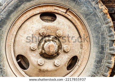 Wheel of an old truck close-up. Rusted rim