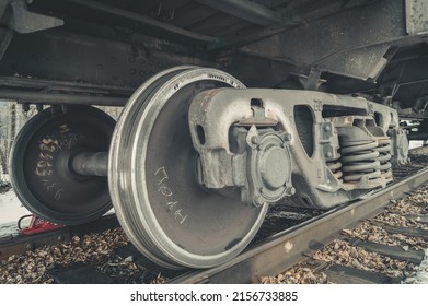 Wheel pairs of a freight railway car. Wheeled trolley of a train car. Steel wheels on rails of the railway. Selective focus