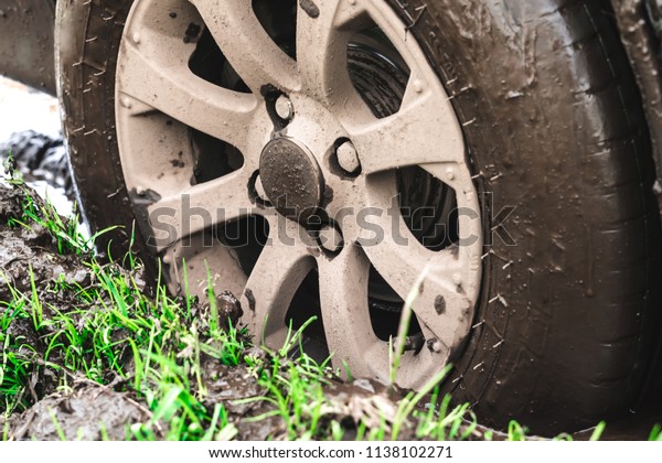 the wheel of a passenger car stuck in the mud on\
an off-road