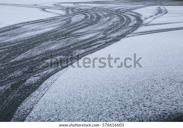 Wheel print on the snowy or icy road after snow\
fall in winter season