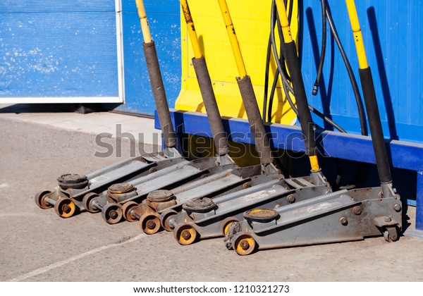 Wheel replacement tools, jacks stand in the line\
near garage wall