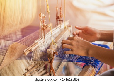 Wheel Spinning Yarn with Yellow Thread to work for Weaving machine and Thai traditional Silk. Artists artisans handicrafts handmade manufacturing motton silk hand loom Thai. 