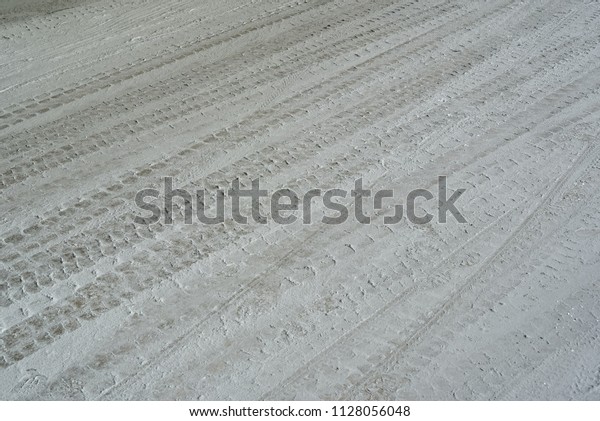 Wheel track and cement powder on cement floor\
for background.