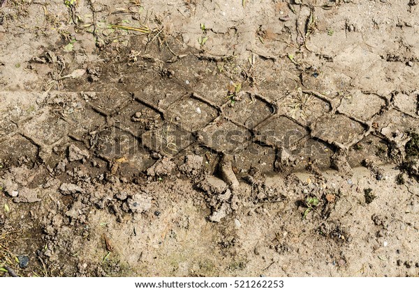 wheel track in the ground. The trace of a tyre in\
the ground.