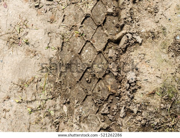 wheel track in the ground. The trace of a tyre in\
the ground.