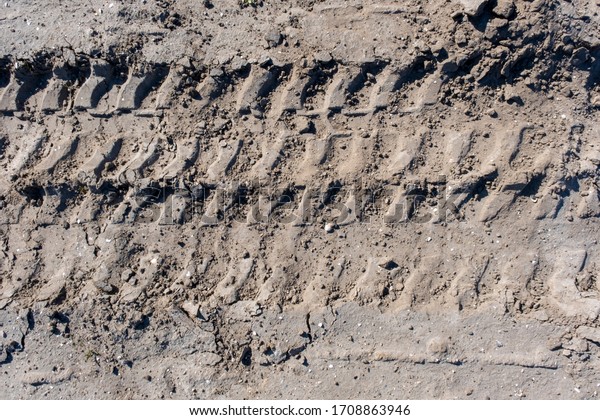 Wheel tracks in\
the mud, detail footprints\
Car