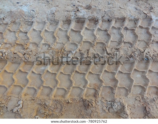 \
Wheel tracks in the mud, detail footprints truck\
in the construction\
road.