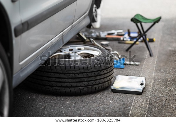 The wheel is under the car. Wheel repair. Wheel\
replacement. Car service.