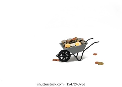 Wheelbarrow with coins on isolated background. Wheelbarrow full of money on a white background.  The concept of shopping, sale. Investments, marketing, trade, internet commerce