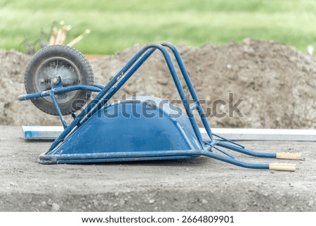 Wheelbarrows and pushcarts at a construction site
