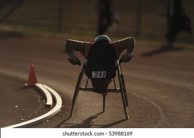 A Wheelchair Athlete Racing During Competition