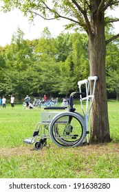 Wheelchair And Crutches In Park