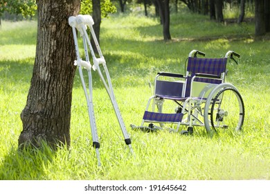 Wheelchair And Crutches In Park