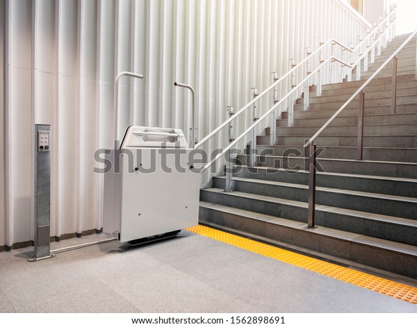 Wheelchair lift with stairs\
Disability elevator Indoor Public building Universal design\
facility 
