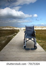 Wheelchair On A Track To The Beach