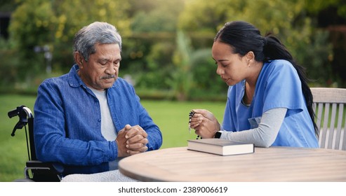 Wheelchair, praying or nurse with senior man for care, support or trust in retirement or nature. Caregiver, help and person or elderly patient with a disability or medical professional for worship - Powered by Shutterstock