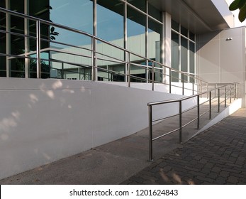 A wheelchair ramp, an inclined plane installed in addition to or instead of stairs, Slope walkway for disabled people, people pushing strollers, carts with stainless bars to prevent falling