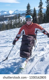 Wheelchair Slalom Skier Riding A Mono Ski From The Snow Mountains - Winter Sport Active Handicapped Rehabilitation 