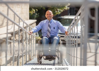 Wheelchair User Up The Ramp