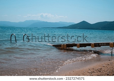 A wheelchair-accessible beach designed with accessibility features including ramps and pathways. Greece is taking steps towards inclusivity by making 287 beaches fully wheelchair-friendly.