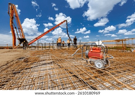 Wheeled electrical aggregate, generator with electric engine, for industrial power tool, unit to plug, outlet for several vibrators, vibrator are use to compact fresh concrete at building site.