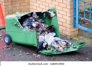 Wheelie bin vandalism on side burnt out by fire by vandals in council estate London arson attack