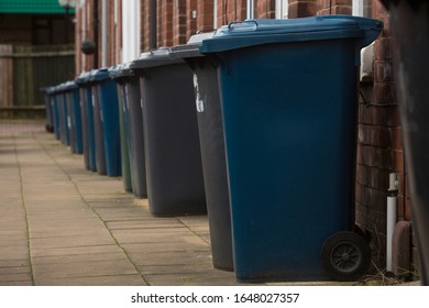 Wheelie refuse rubbish waste bins outside England United Kingdom UK terrace houses