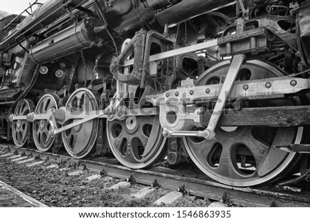 wheels of an ancient locomotive close-up, retro vehicle, black and white photo