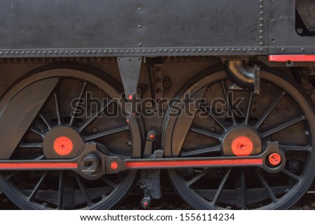 the wheels of a black steam locomotive