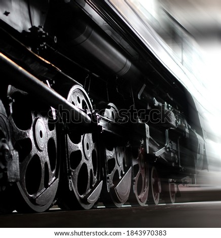 Wheels of an old steam locomotive, train in motion. Close-up shot