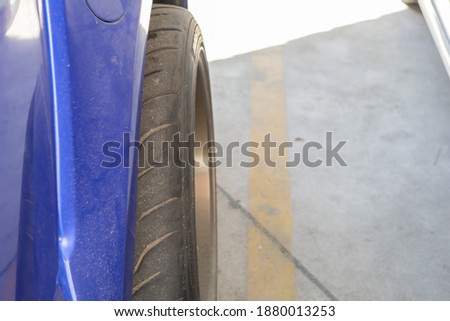 The wheels protrude from the car