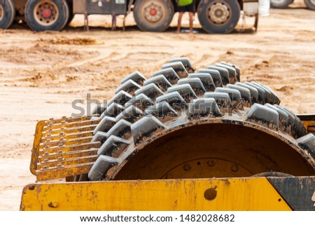 The wheels of a road compactor with strong vibrations for compacting are parked.