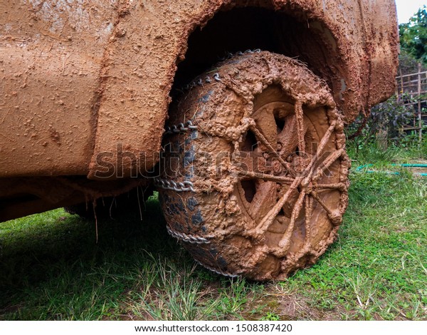 wheels tires and off road truck\
shaft that goes in the and mud through the wheels in the\
forest