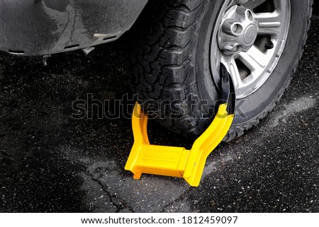 Wheet boot or tire lock on a vehicle or car for illegal parking violation 