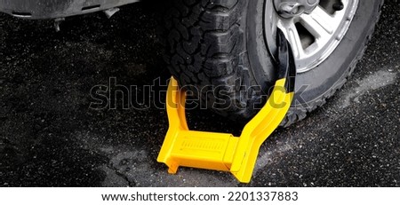 Wheet boot or tire lock on a vehicle or car for illegal parking violation  Imagine de stoc © 