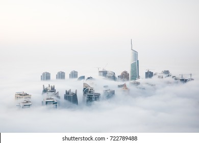 When cold desert air meets warm ocean air at the start of the winter, Dubai witnesses a unique sight of world’s highest skyscrapers drowning in fog. Dubai, UAE. Stock Photo