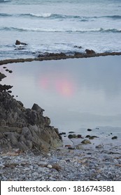 when the colors of the rainbow falls in between the rocks and the water