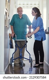 When The Going Gets Tough, Ill Help You Get Going. Shot Of A Female Nurse Assisting Her Senior Patient Whos Using A Walker For Support.