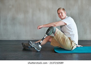 When The Mind Is Strong, The Body Follows. Shot Of A Young Amputee Working Out On A Gym Floor.