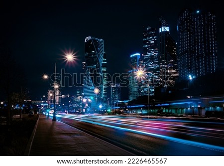 When night changes the day, night comes and street lights are lit on the streets and passing cars leave behind them tracers that fly after the car trying to catch up with it