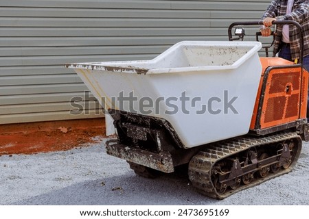 When pouring concrete, workers use dumper tracked wheelbarrows