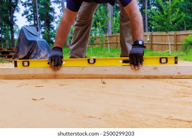 When preparing platform for installation of swimming pool in backyard, leveling sand