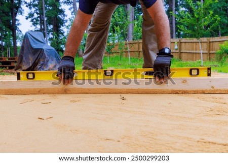 When preparing platform for installation of swimming pool in backyard, leveling sand