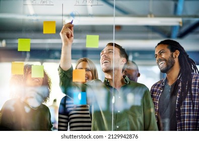 When productivity is a group activity. Shot of colleagues having a brainstorming session with sticky notes at work. - Powered by Shutterstock